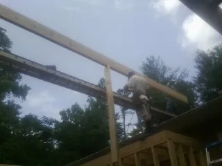 Carpenter setting a ridge beam over a new addition frame — Ice Dam Removal by Roofing Brothers in East Liverpool