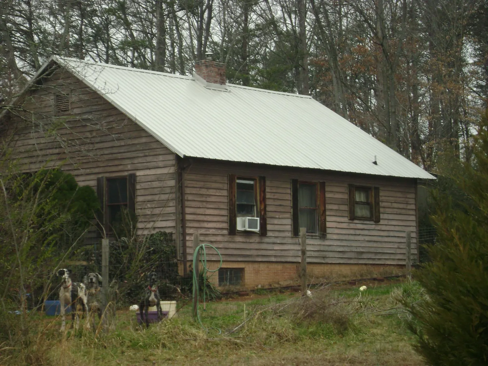 White metal roof on an old wood sided farmhouse, from a Metal Roof Installation job in East Liverpool